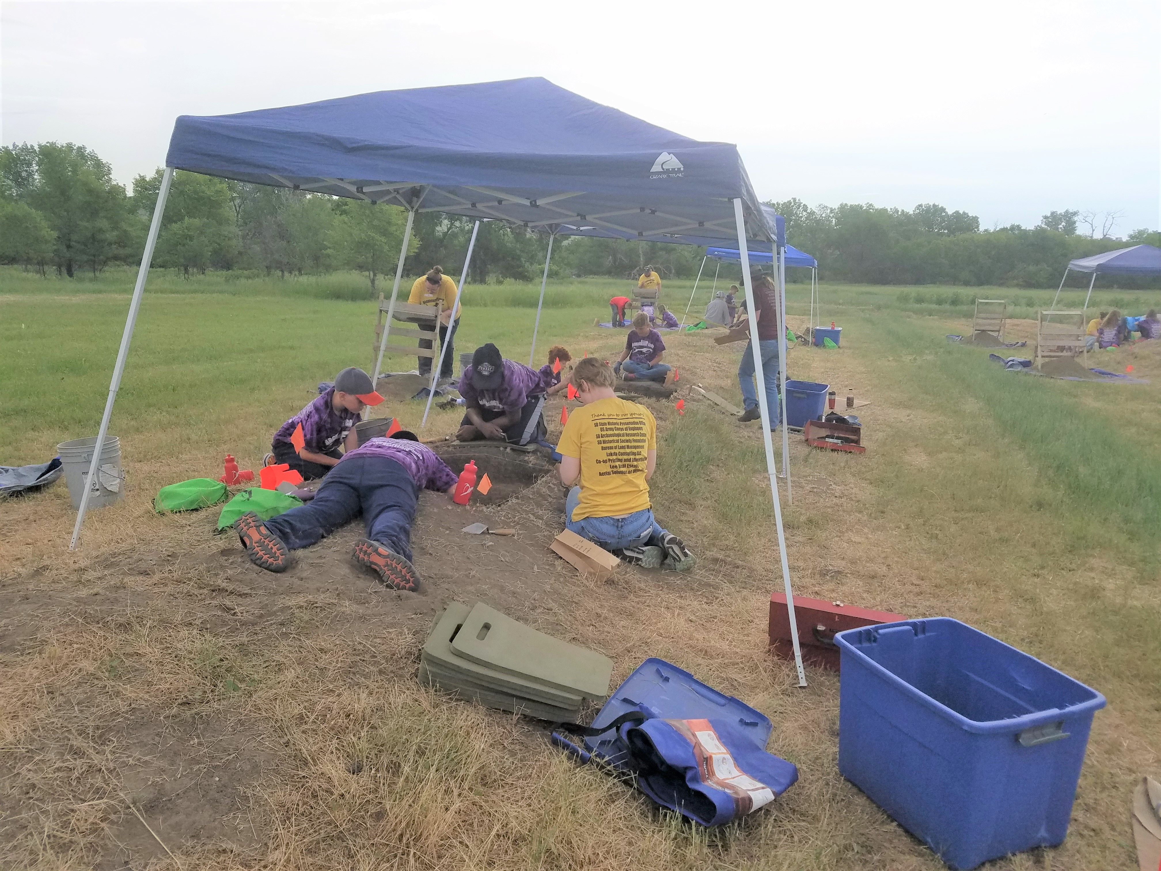 Archaeology Camp 2018 participants excavating pits.